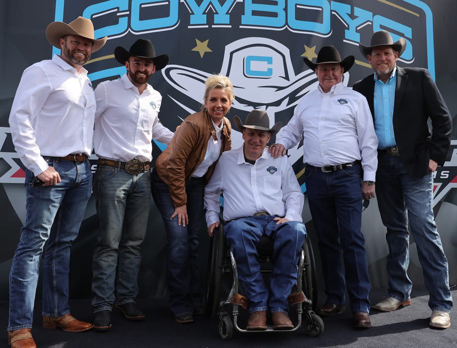 Carolina Cowboys team poses in front of team sign