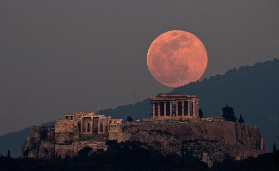 A supermoon rises over the Parthenon on the ancient Acropolis Hill in Athens, Greece, on Feb. 19, 2019. 