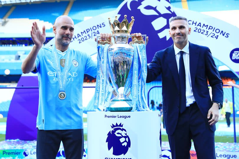 Pep Guardiola and Khaldoon Al Mubarak with the Premier League trophy