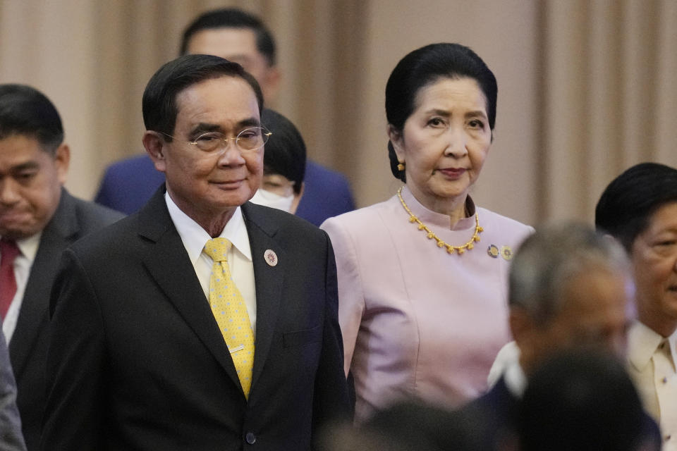 Thailand's Prime Minister Prayuth Chan-o-cha, left, and his wife Naraporn Chan-ocha arrive for the opening ceremony of the 40th and 41st ASEAN Summits (Association of Southeast Asian Nations) in Phnom Penh, Cambodia, Friday, Nov. 11, 2022. The ASEAN summit kicks off a series of three top-level meetings in Asia, with the Group of 20 summit in Bali to follow and then the Asia Pacific Economic Cooperation forum in Bangkok. (AP Photo/Vincent Thian)