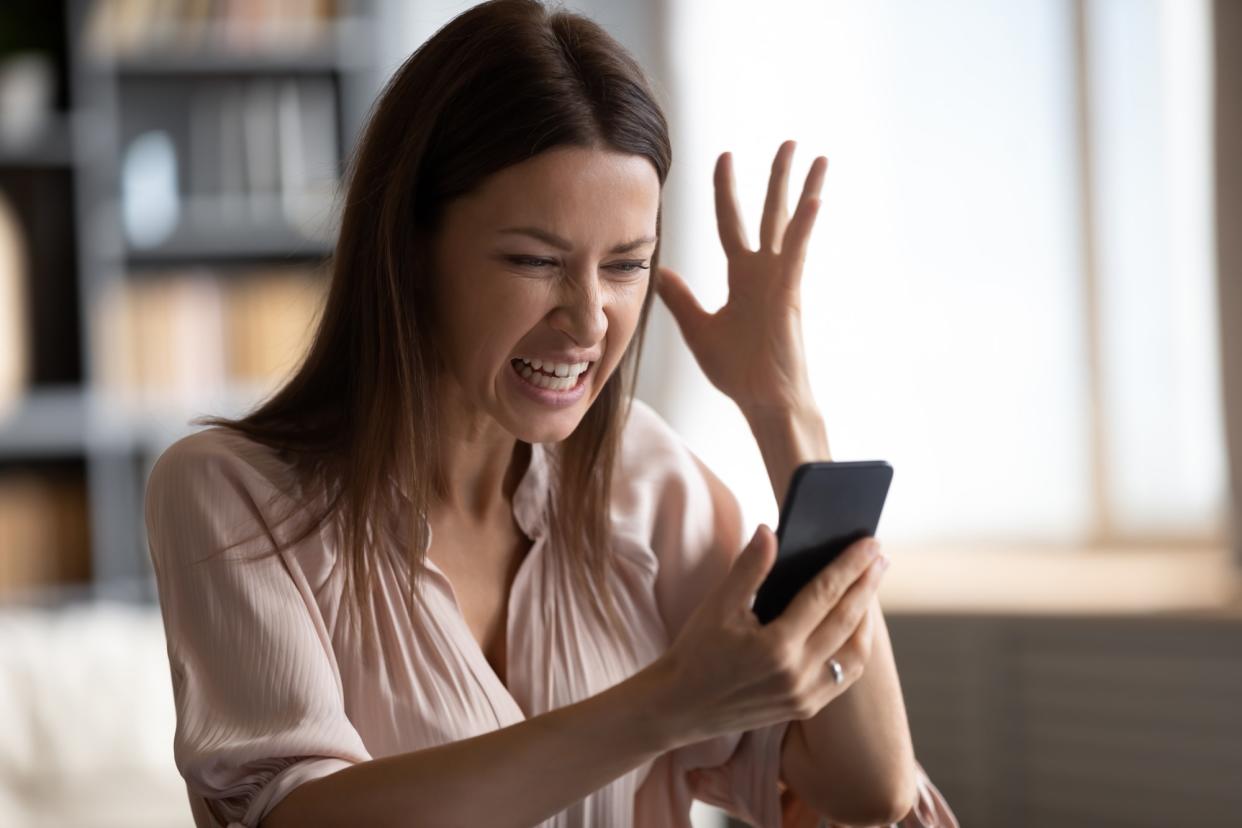 Mad female having problems working on modern cellphone