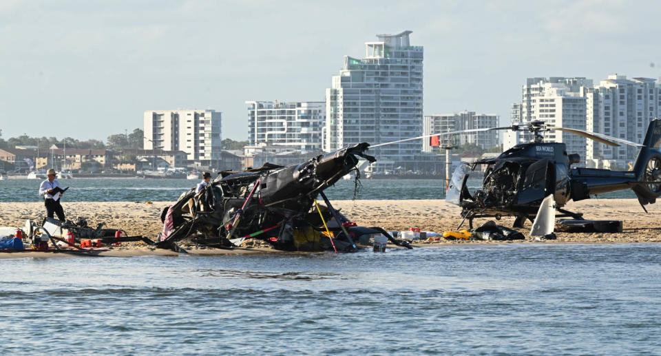 The two helicopters sit on a sandbank in the wake of the crash. Source: AAP