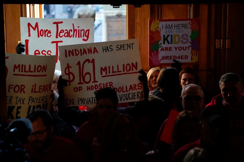 Educators and their supports enter the Capitol Building as teachers hold a one day walkout at the statehouse in Indianapolis