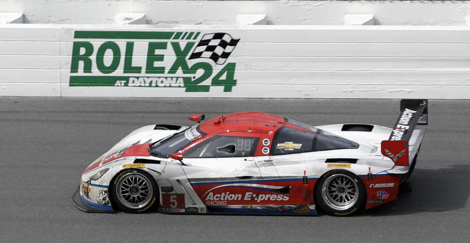 Sebastian Bourdais, of France, drives the Action Express Racing Corvette DP through the front stretch during the IMSA Series Rolex 24 hour auto race at Daytona International Speedway in Daytona Beach, Fla., Sunday, Jan. 26, 2014.(AP Photo/John Raoux)