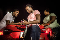 <p>Claressa chats with friends including her sparring partner Rell, outside a bowling alley in Flint, Mich. Rell and Claressa had a crush on each other for years and were dating behind the back of her coach. Eventually it led to the end of her working with Coach Jason. Rell and Ressa were still dating in 2015, when this photo was captioned. (Photograph by Zackary Canepari) </p>