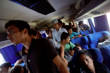 Central American migrants, part of a caravan moving through Mexico toward the U.S. border, get off the bus upon their arrival in Puebla, Mexico April 6, 2018. REUTERS/Edgard Garrido