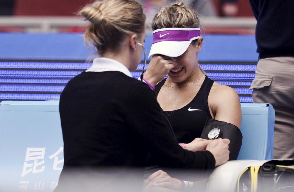 Eugenie Bouchard of Canada is treated after suffering from dizziness during her return match against Andrea Petkovic in Beijing, China last fall. (REUTERS) 