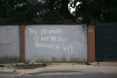 A warning sign is seen on the boundary wall of a house in the Ikoyi district in Nigeria's commercial capital Lagos August 20, 2013. REUTERS/Akintunde Akinleye