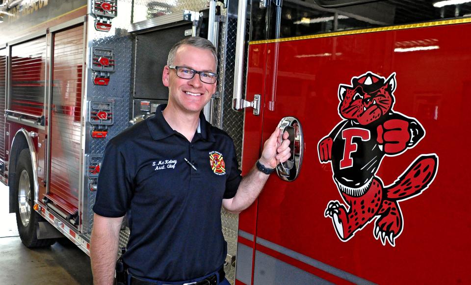 Fredericksburg Assistant Fire Chief Shawn McKelvey stands next to the department's mascot, Fredericksburg Freddie. Freddie was the mascot of Fredericksburg High School, which soon will be the location of the new fire department building.