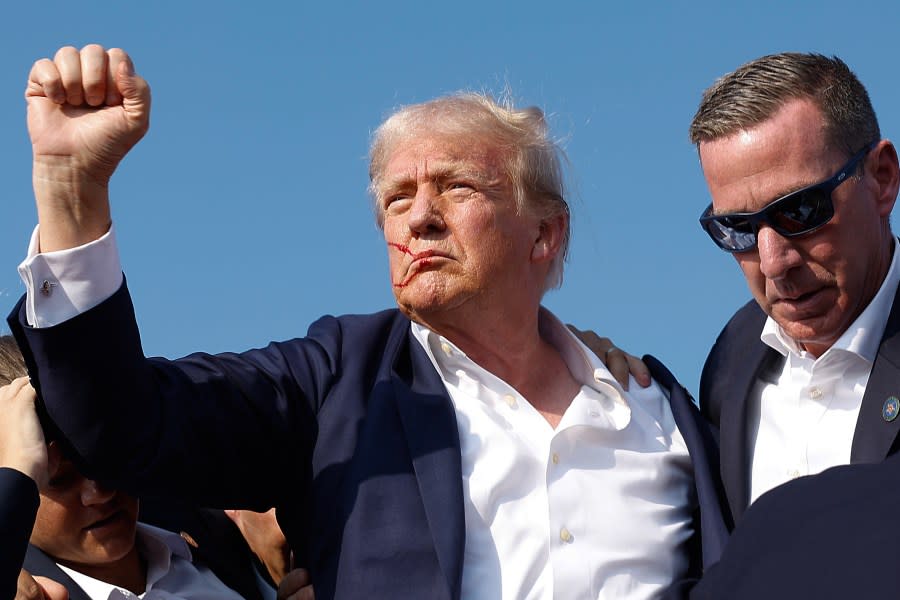 BUTLER, PENNSYLVANIA – JULY 13: Republican presidential candidate former President Donald Trump pumps his fist as he is rushed offstage by U.S. Secret Service agents after being grazed by a bullet during a rally on July 13, 2024 in Butler, Pennsylvania. (Photo by Anna Moneymaker/Getty Images)