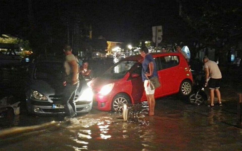 People try to move the cars from a flooded coastal road after  - Credit: Kos Today