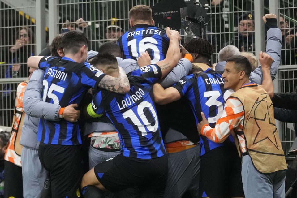 Inter Milan's Marko Arnautovic celebrates with team mates after scoring his side's opening goal during the Champions League, round of 16, first leg soccer match between Inter Milan and Atletico Madrid, at the San Siro stadium in Milan, Italy, Tuesday, Feb. 20, 2024. (AP Photo/Luca Bruno)