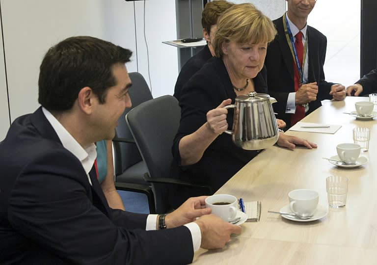 Angela Merkel with Greek Prime Minister Alexis Tsipras at EU headquarters in Brussels on July 7, 2015
