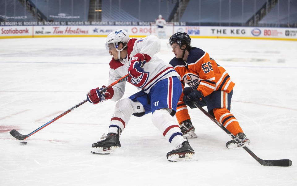 Edmonton Oilers' Kailer Yamamoto (56) chases Montreal Canadiens' Brendan Gallagher (11) during third-period NHL hockey game action in Edmonton, Alberta, Monday, Jan. 18, 2021. (Jason Franson/The Canadian Press via AP)