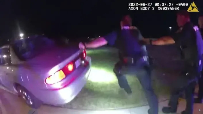 Bodycam footage shows Akron police behind a car.