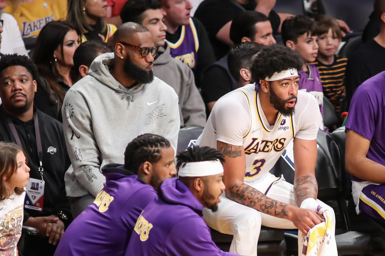 Los Angeles Lakers forward LeBron James sits with Anthony Davis