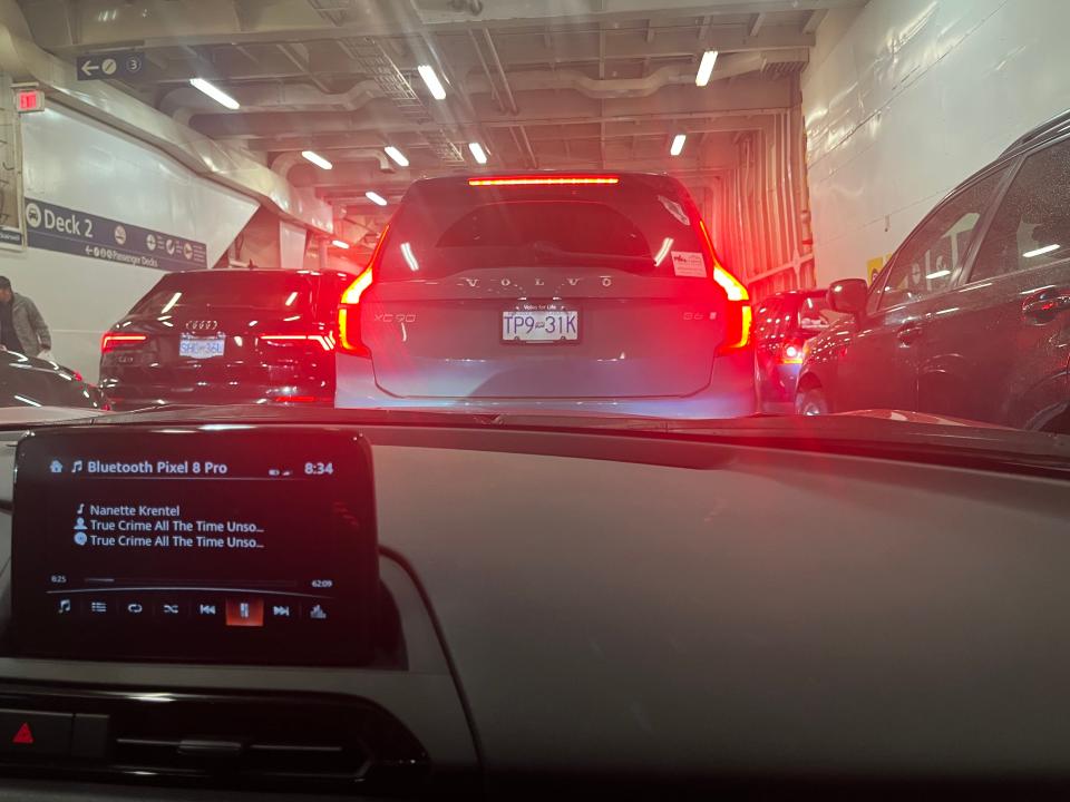 cars parked on a ferry deck waiting to drive off