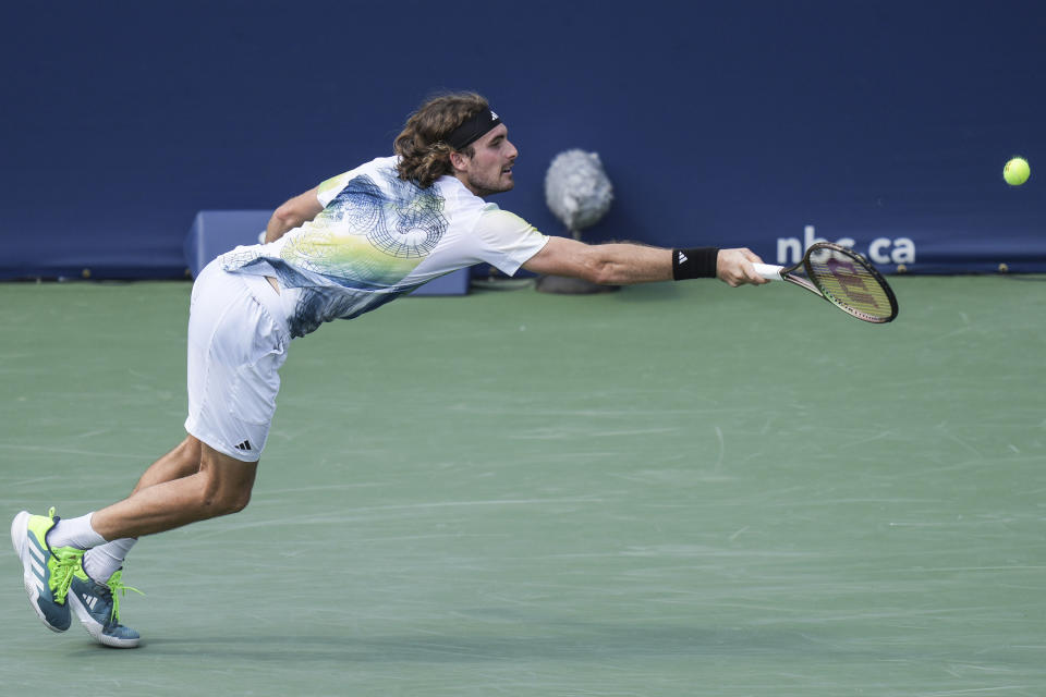 Greece's Stefanos Tsitsipas stretches for a shot during his straight sets defeat to France's Gael Monfils during the National Bank Open tennis tournament in Toronto, Wednesday, Aug. 9, 2023. (Chris Young/The Canadian Press via AP)