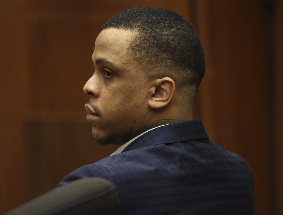 Defendant Eric Holder listens during opening statements in his murder trial, Wednesday, June 15, 2022, at Los Angeles Superior Court in Los Angeles. Holder, 32, faces one count of first degree-murder and two counts of attempted first-degree murder for the killing the Grammy Award-winning rapper Nipsey Hussle outside his clothing store three years ago. (Frederick M. Brown/Daily Mail.com via AP, Pool)