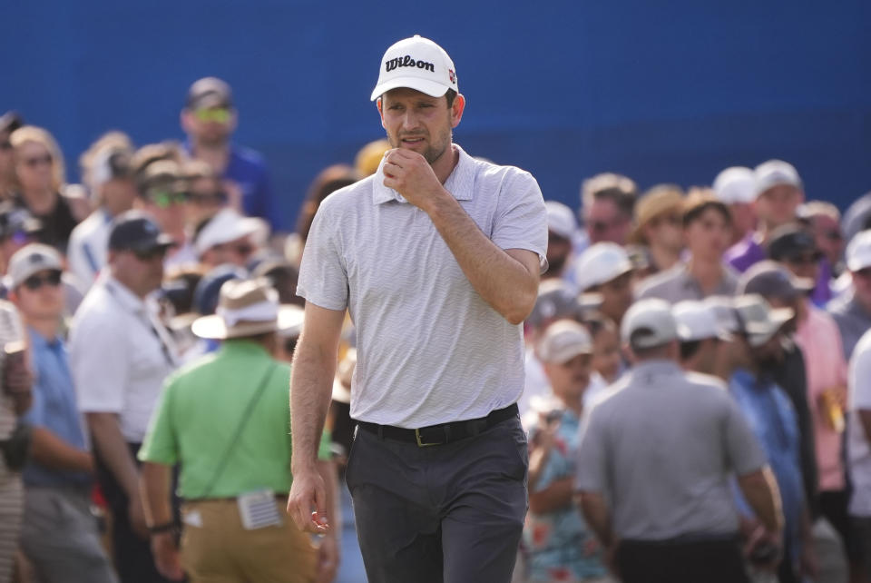 Martin Trainer sizes up his shot from the gallery of the 18th green during playoff for the PGA Zurich Classic golf tournament at TPC Louisiana in Avondale, La., Sunday, April 28, 2024. The team of Rory McIlroy, of Northern Ireland, and Shane Lowry, of Ireland, won the playoff to capture the trophy. (AP Photo/Gerald Herbert)