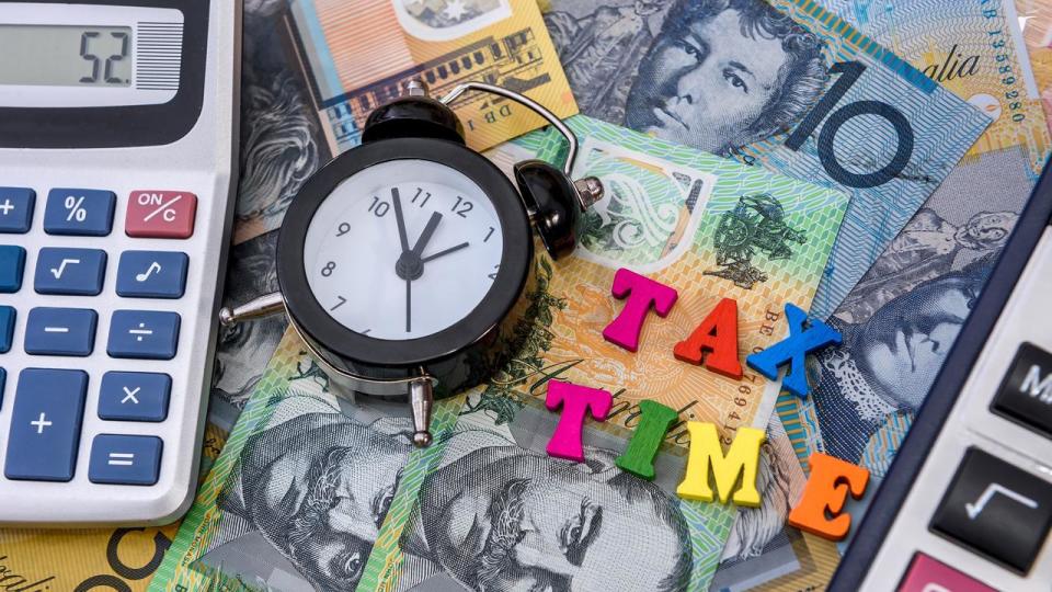 Australian dollars with clock and 'tax time' text