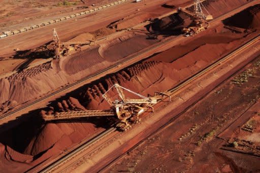 Handout photo from BHP Billiton shows iron ore being stockpiled for export in Western Australia. Analysts say government spending in Australia was weakening despite the mining boom