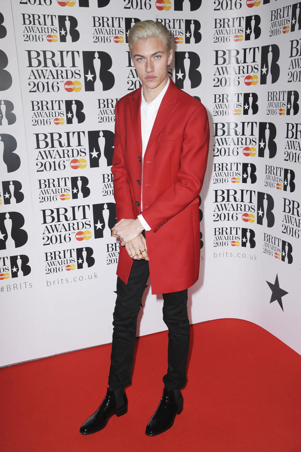 Lucky Blue Smith in a red suit jacket. 