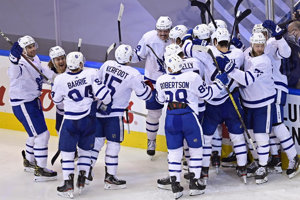 Toronto Maple Leafs players celebrate their victory over the Columbus Blue Jackets in overtime of an NHL hockey playoff game Friday, Aug. 7, 2020, in Toronto. (Frank Gunn/The Canadian Press via AP)