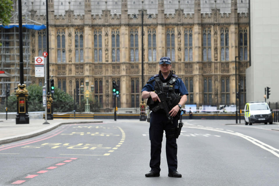 Armed police on Victoria Embankment in Westminster, central London, after a car crashed into security barriers outside the Houses of Parliament (PA)