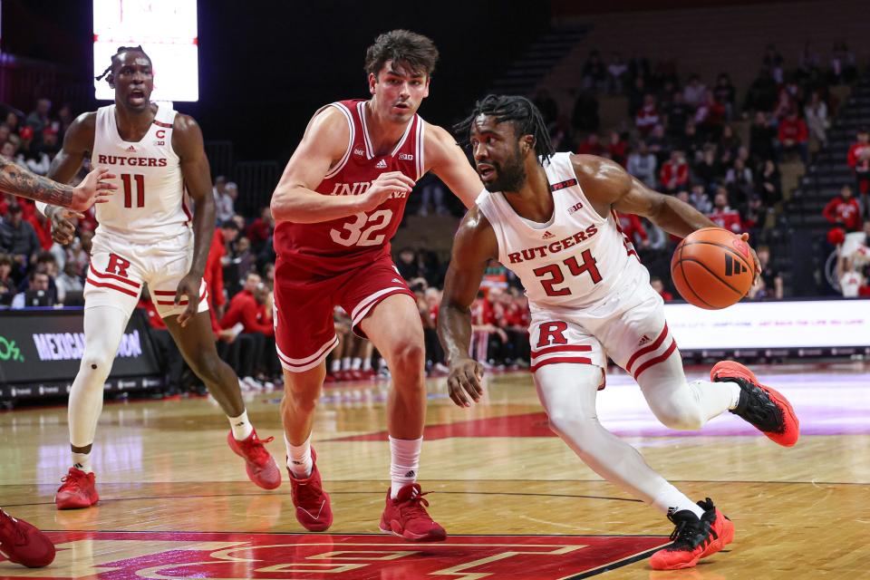Jan 9, 2024; Piscataway, New Jersey, USA; Rutgers Scarlet Knights guard Austin Williams (24) dribbles against Indiana Hoosiers guard Trey Galloway (32) during the second half at Jersey Mike's Arena.