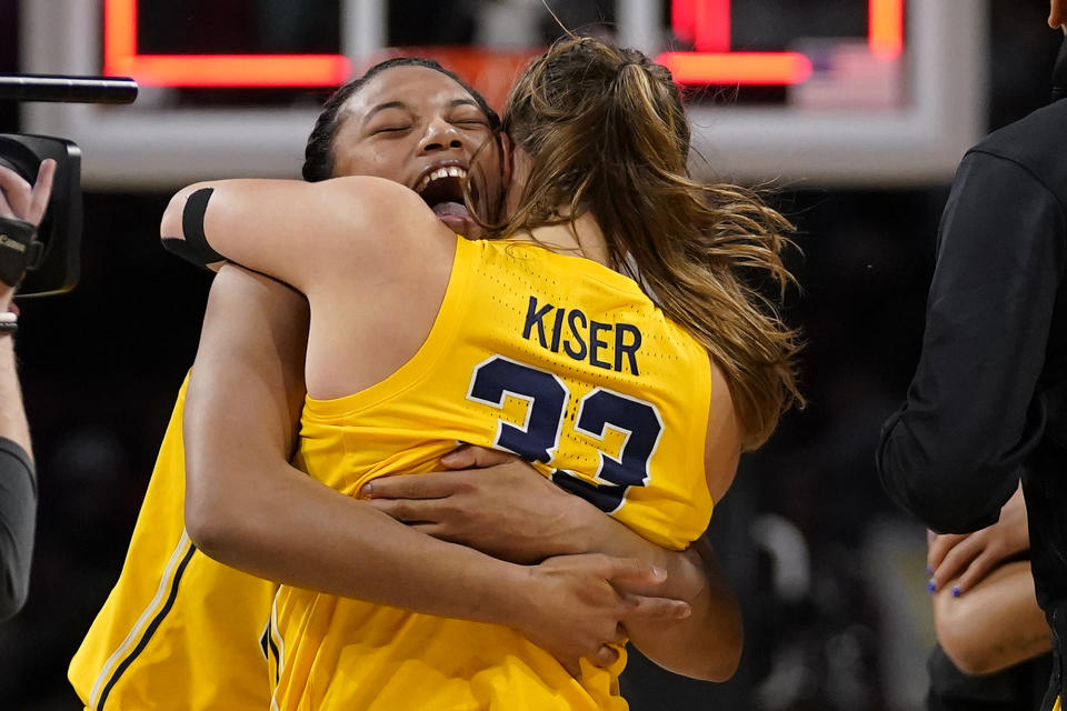 Michigan's Naz Hillmon, left, and Emily Kiser celebrate a 52-49 victory over South Dakota following a college basketball game in the Sweet 16 round of the NCAA women's tournament Saturday, March 26, 2022, in Wichita, Kan. (AP Photo/Jeff Roberson)