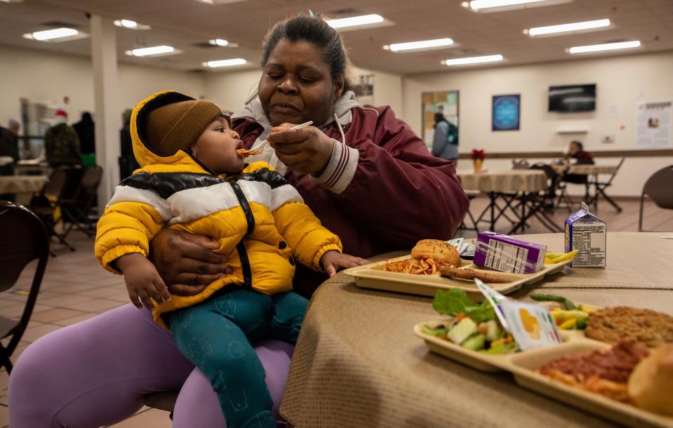 Delois Weathers feeds her grandson inside the Capuchin Soup Kitchen in Detroit on Thursday, Dec. 7, 2023. The program is close to a century old; it has been serving the Detroit community since 1929.