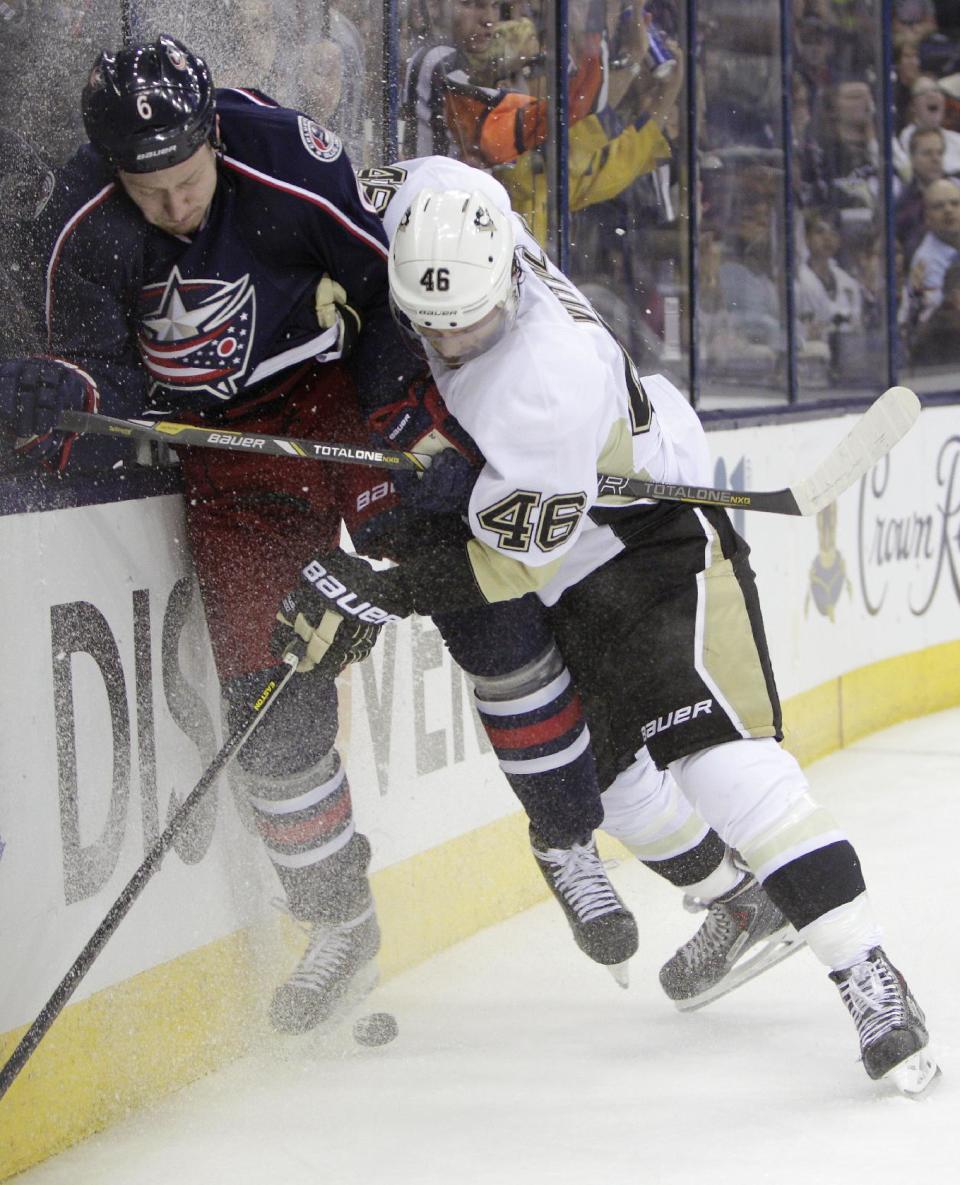Pittsburgh Penguins' Joe Vitale, right, checks Columbus Blue Jackets' Nikita Nikitin, of Russia, during the third period of a first-round NHL playoff hockey game Monday, April 21, 2014, in Columbus, Ohio. The Penguins defeated the Blue Jackets 4-3. (AP Photo/Jay LaPrete)