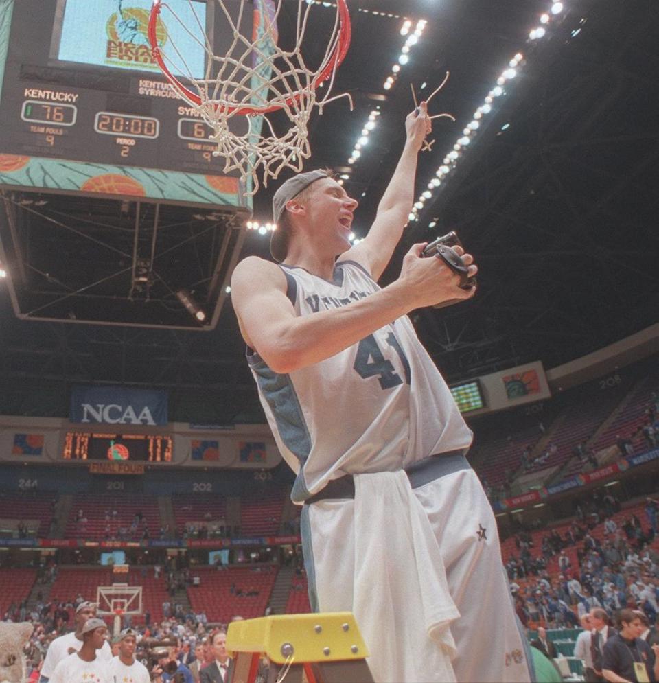 Mark Pope cut down the net after helping Kentucky win the 1996 national championship. David Perry/Herald-Leader File Photo