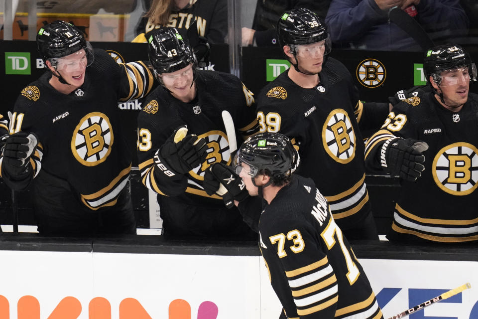 Boston Bruins defenseman Charlie McAvoy (73) is congratulated after his goal against Florida Panthers goaltender Sergei Bobrovsky during the third period of an NHL hockey game, Monday, Oct. 30, 2023, in Boston. (AP Photo/Charles Krupa)