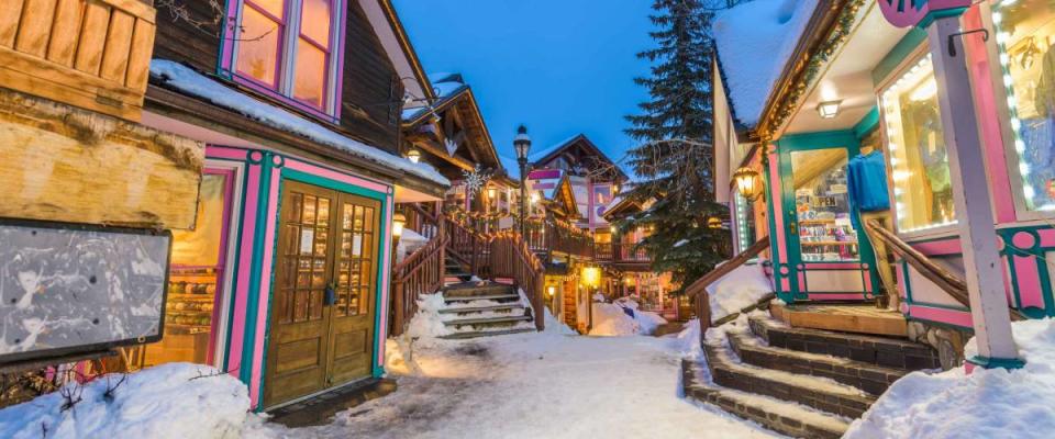 Breckenridge, Colorado, USA downtown streets at night in the winter with holiday lighting.