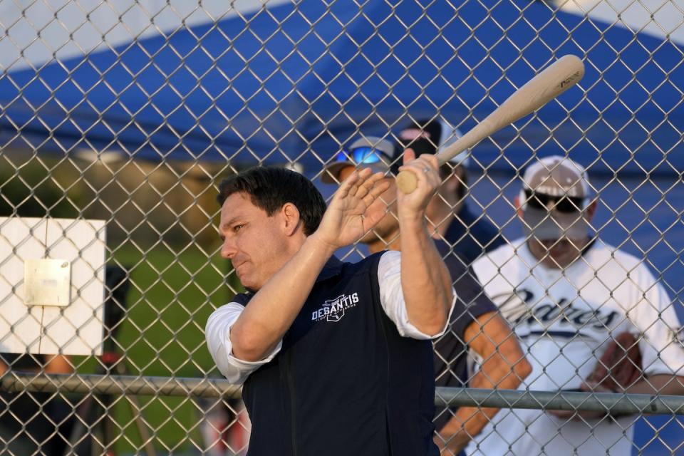 Florida Gov. Ron DeSantis swings a baseball bat during a presidential campaign stop in Iowa in August 2023. <a href="https://newsroom.ap.org/detail/Election2024DeSantis/3e78128c336546f3b3cb79f4894e0589/photo" rel="nofollow noopener" target="_blank" data-ylk="slk:AP Photo/Charlie Neibergall;elm:context_link;itc:0;sec:content-canvas" class="link ">AP Photo/Charlie Neibergall</a>