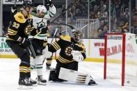 CORRECTS THAT JAMIE BENN, NOT JOHN KLINKBERG, SCORED THE GOAL (CHANGE IN OFFICIAL SCORING) - Boston Bruins' Jaroslav Halak, right, looks back at a goal by Dallas Stars' Jamie Benn (14) as Bruins' Zdeno Chara (33) defends against Benn during the first period of an NHL hockey game in Boston, Thursday, Feb. 27, 2020. (AP Photo/Michael Dwyer)