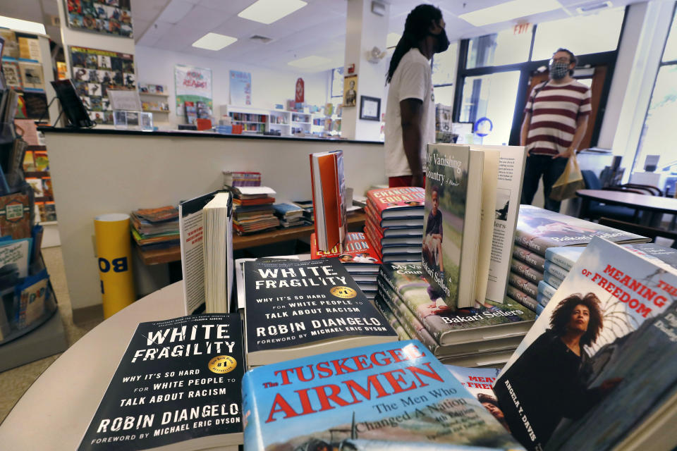 In this Wednesday, June 24, 2020, photograph, books are displayed, including "The Tuskegee Airmen," and "White Fragility," at the Black-owned Frugal Bookstore in the Roxbury neighborhood of Boston. Many from outside Boston have recently shopped and supported the store amid nationwide protests against racism. (AP Photo/Charles Krupa)