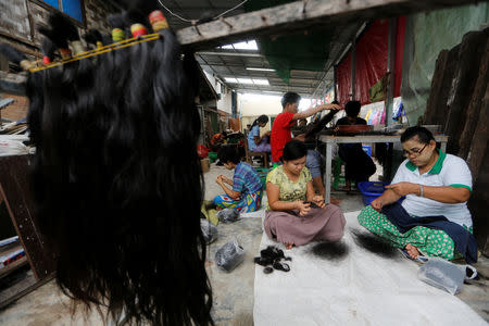 Workers clean the hair for export at Tet Nay Lin Trading Co. in Yangon, Myanmar, June 19, 2018. REUTERS/Ann Wang