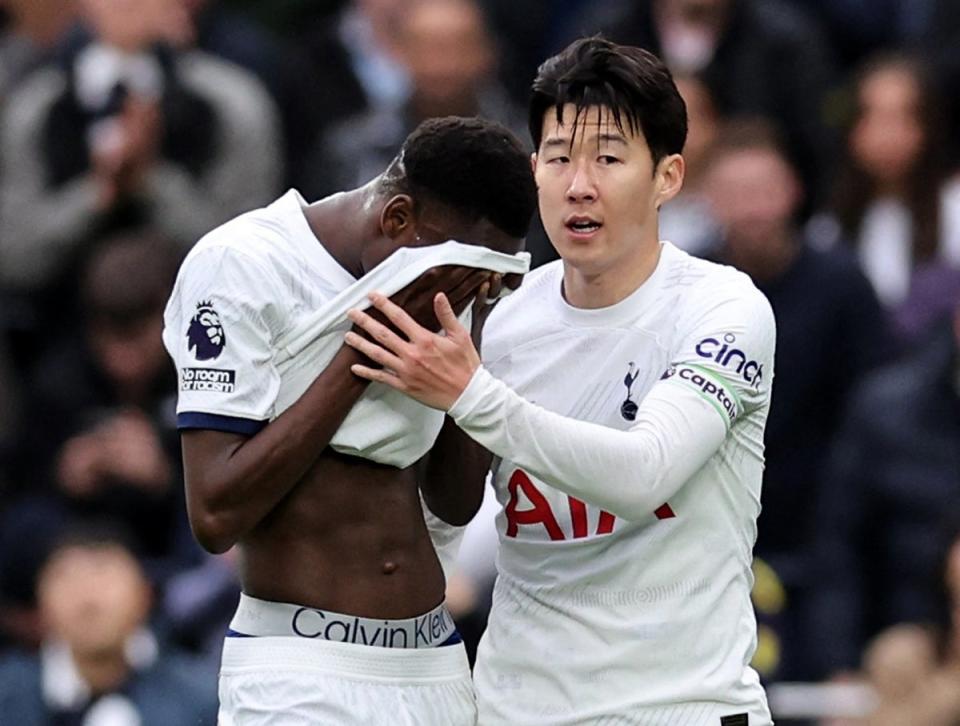 Tearful: Pape Sarr is helped off the pitch by skipper Heung-min Son on Sunday (REUTERS)