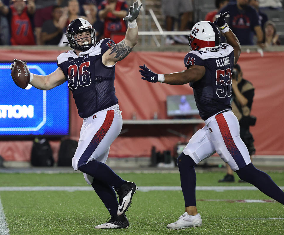 HOUSTON, TEXAS - FEBRUARY 26: Jack Heflin #96 of the Houston Roughnecks celebrates with Emmanuel Ellerbee #52 after recovering a fumble by Drew Plitt #9 of the Arlington Renegades in the second half at TDECU Stadium on February 26, 2023 in Houston, Texas. (Photo by Bob Levey/Getty Images)