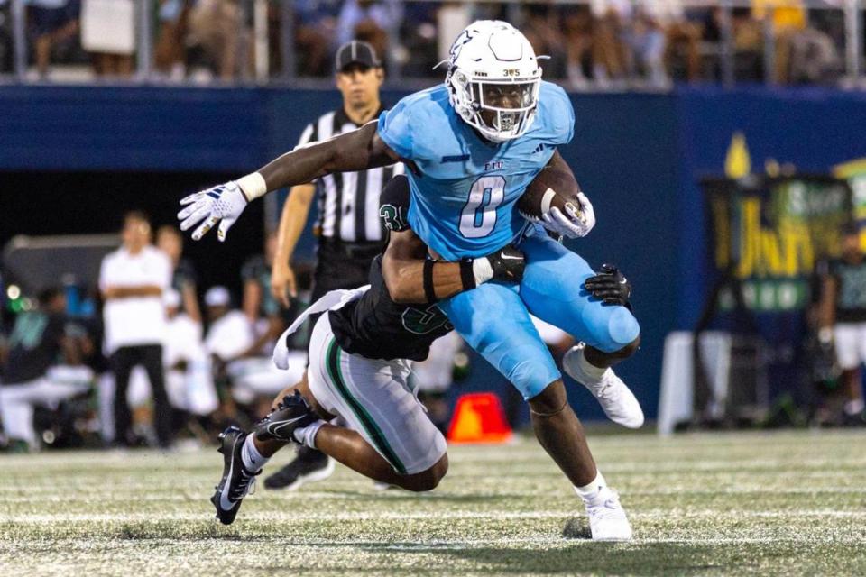 Florida International University running back Shomari Lawrence (0) runs the ball while chased by North Texas linebacker Jaylen Smith (36) during the first half of a college football game at Riccardo Silva Stadium in Miami, Florida, on Saturday, September 9, 2023.