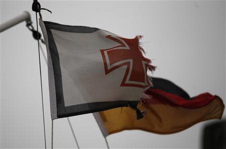 Flags are seen on the North Sea beach near the town of Norddeich, December 5, 2013. REUTERS/Ina Fassbender