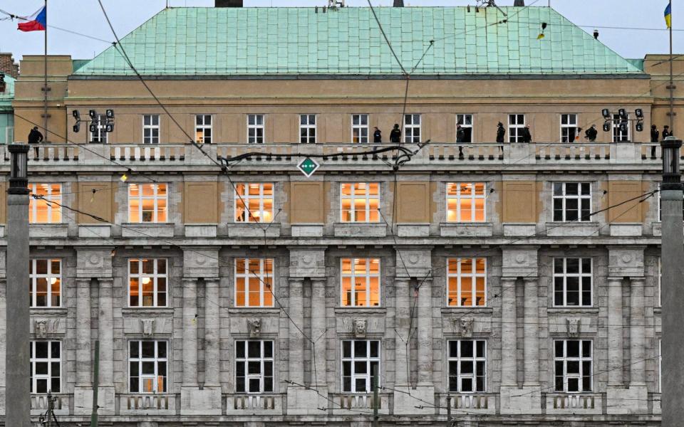 Armed police are seen on the balcony of the university in central Prague