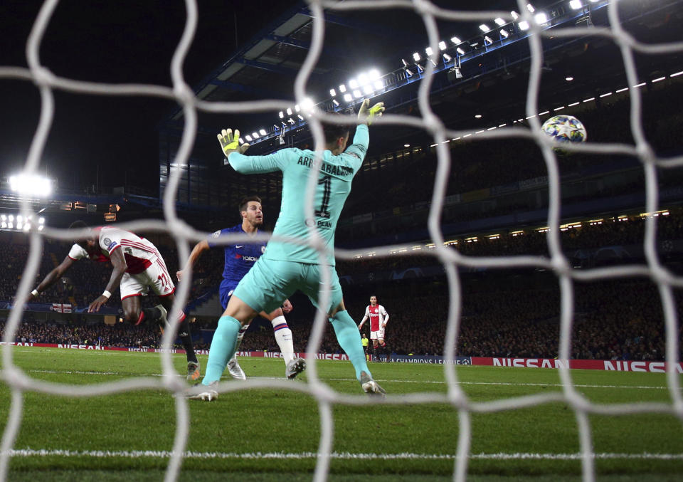 Ajax's Quincy Promes, left, scores his side's second goal during the Champions League, group H, soccer match between Chelsea and Ajax, at Stamford Bridge in London, Tuesday, Nov. 5, 2019. (AP Photo/Ian Walton)