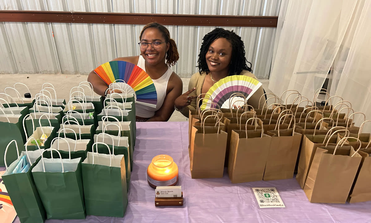 This is a photo of San Antonio college students at a table with free emergency contraceptives.