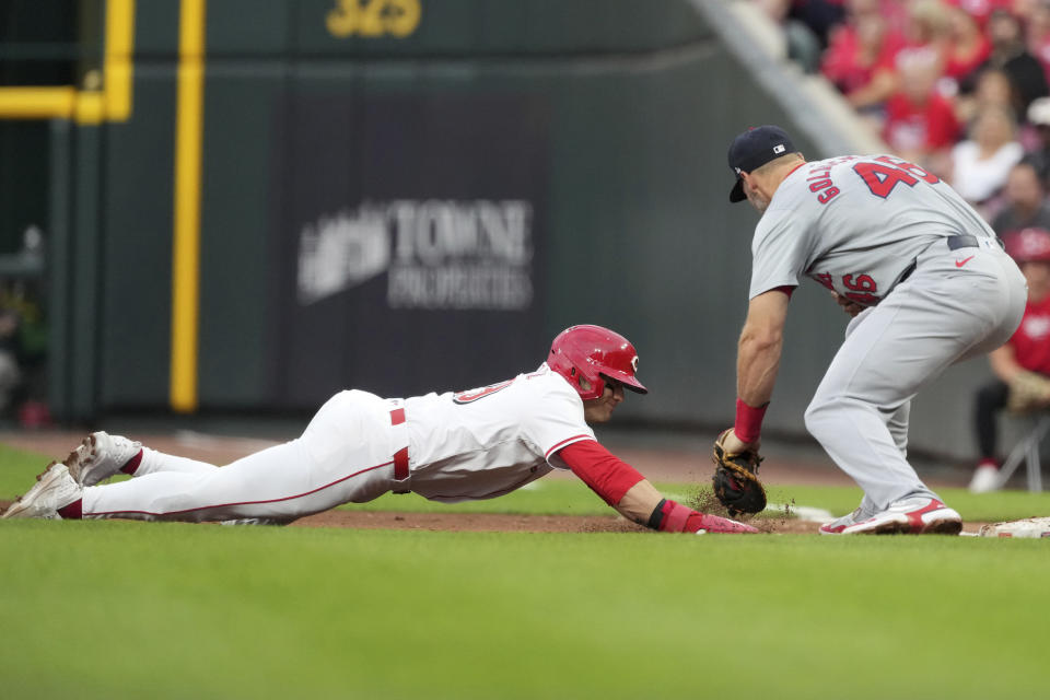 Cincinnati Reds' TJ Friedl is picked off first as St. Louis Cardinals' Paul Goldschmidt makes the tag during the third inning of a baseball game, Tuesday, Aug. 13, 2024, in Cincinnati. (AP Photo/Kareem Elgazzar)