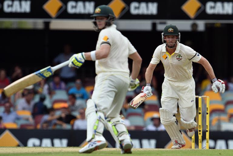 Australia's Shaun Marsh (R) and Steve Smith run between the wickets during the second day of their 2nd Test match against India, at The Gabba in Brisbane, on December 18, 2014