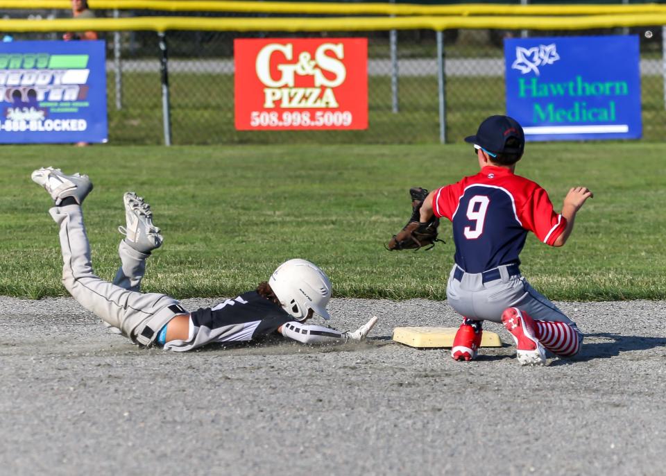 Tae Rose of Table 8 dives back into second base while N.B. Fire second baseman Ben Willis awaits the throw from his outfielder.